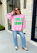 Add a little western attitude to your cozy season! This playful pink mock neck sweatshirt features a bold "Cool It, Cowboy" graphic in textured green striped lettering for the perfect mix of retro charm and everyday comfort. The ribbed neckline, cuffs, and hem give this fleece-lined pullover an elevated finish, making it a standout piece you'll love wearing on crisp fall days.