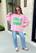 Add a little western attitude to your cozy season! This playful pink mock neck sweatshirt features a bold "Cool It, Cowboy" graphic in textured green striped lettering for the perfect mix of retro charm and everyday comfort. The ribbed neckline, cuffs, and hem give this fleece-lined pullover an elevated finish, making it a standout piece you'll love wearing on crisp fall days.