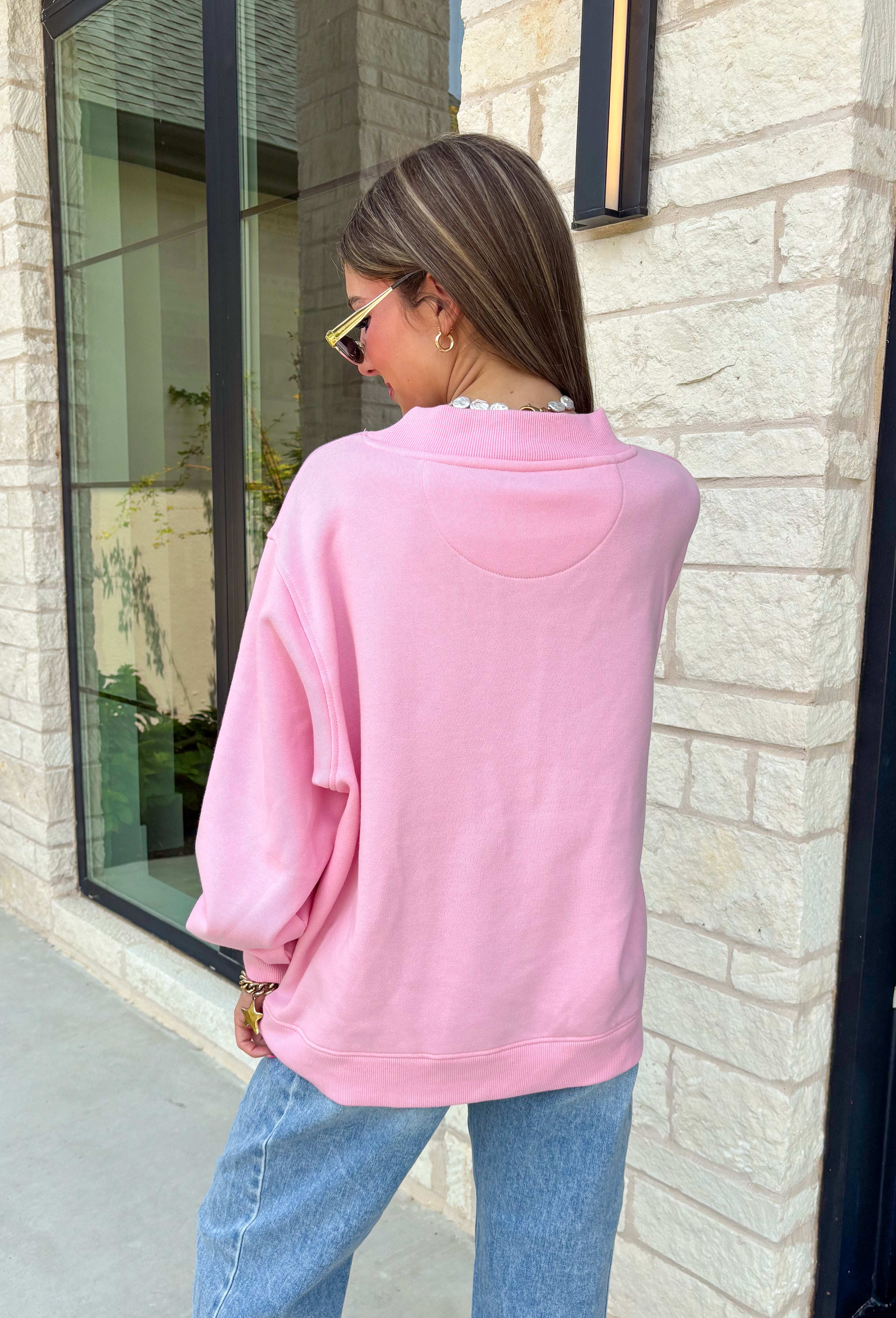 Add a little western attitude to your cozy season! This playful pink mock neck sweatshirt features a bold "Cool It, Cowboy" graphic in textured green striped lettering for the perfect mix of retro charm and everyday comfort. The ribbed neckline, cuffs, and hem give this fleece-lined pullover an elevated finish, making it a standout piece you'll love wearing on crisp fall days.