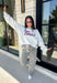 Show your Texas pride in the coziest way possible! This ash grey mock neck sweatshirt blends everyday comfort with timeless style, featuring "Texas" in soft script across the chest and a sweet heart detail on the sleeve. The fleece-lined interior keeps you warm and cozy, while the classic silhouette makes it an easy favorite for everything from football Saturdays and coffee runs to relaxed weekends at home. 