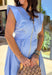 Clean, fresh, and effortlessly flattering, this light blue midi dress by Entro is the definition of easy spring style. Designed with a v-neck zip-front and soft cap sleeves, it feels modern yet timeless. Textured stitching bands add subtle detail, while the smocked back waistband creates a comfortable, flattering shape. Finished with side pockets and a full lining, this dress is perfect for spring days that call for something polished but still comfortable.