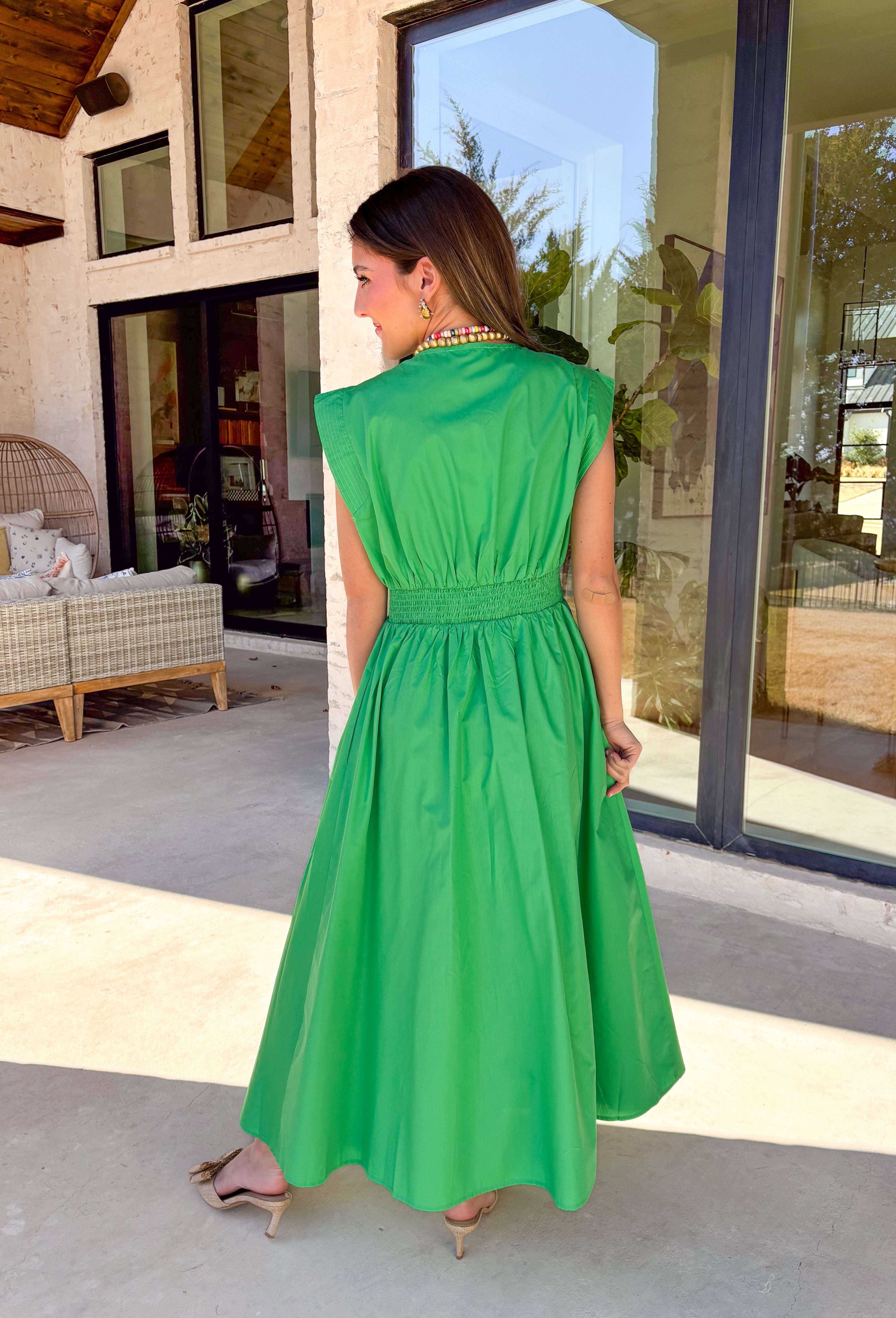 Clean, fresh, and effortlessly flattering, this green midi dress by Entro is the definition of easy spring style. Designed with a v-neck zip-front and soft cap sleeves, it feels modern yet timeless. Textured stitching bands add subtle detail, while the smocked back waistband creates a comfortable, flattering shape. Finished with side pockets and a full lining, this dress is perfect for spring days that call for something polished but still comfortable.