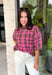 Add a cozy pop of pattern to your everyday wardrobe with this charming sweater from Entro. Designed in a pink and brown plaid knit, this short sleeve sweater is the perfect blend of classic style and seasonal warmth. The soft, cozy knit makes it comfortable enough for all-day wear, while the timeless plaid pattern adds effortless charm to any outfit. 