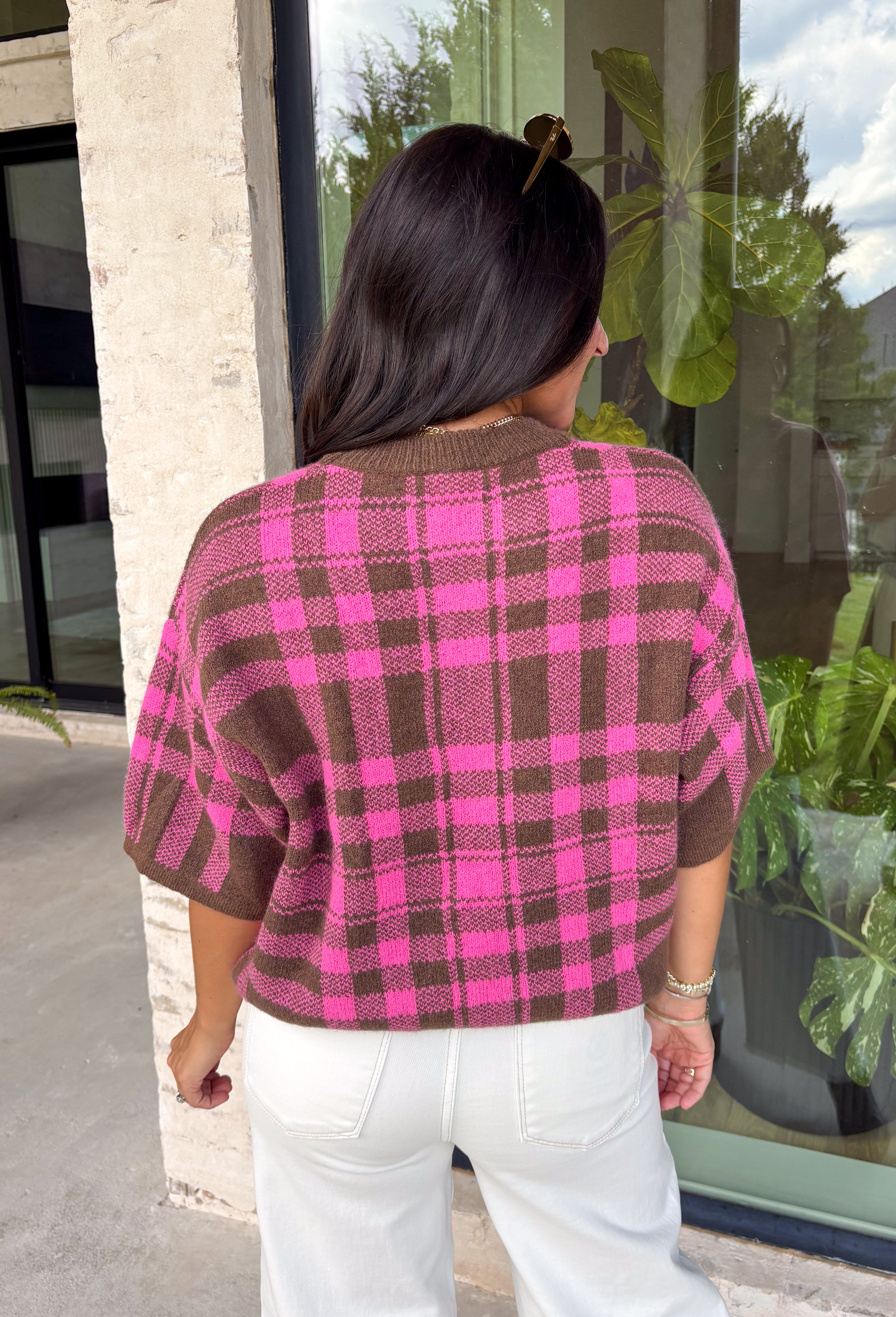 Add a cozy pop of pattern to your everyday wardrobe with this charming sweater from Entro. Designed in a pink and brown plaid knit, this short sleeve sweater is the perfect blend of classic style and seasonal warmth. The soft, cozy knit makes it comfortable enough for all-day wear, while the timeless plaid pattern adds effortless charm to any outfit. 