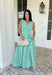 Fresh, crisp, and made for sunny days! This green and white stripe sleeveless midi dress brings a clean, classic look with just the right touch of femininity. The subtle ruffle detail along the sleeves adds a soft, playful feel, while the tailored silhouette keeps it polished and easy to wear. Designed with a hint of stretch and smocking along the back, this dress offers a comfortable, flattering fit. 