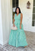 Fresh, crisp, and made for sunny days! This green and white stripe sleeveless midi dress brings a clean, classic look with just the right touch of femininity. The subtle ruffle detail along the sleeves adds a soft, playful feel, while the tailored silhouette keeps it polished and easy to wear. Designed with a hint of stretch and smocking along the back, this dress offers a comfortable, flattering fit. 