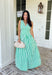 Fresh, crisp, and made for sunny days! This green and white stripe sleeveless midi dress brings a clean, classic look with just the right touch of femininity. The subtle ruffle detail along the sleeves adds a soft, playful feel, while the tailored silhouette keeps it polished and easy to wear. Designed with a hint of stretch and smocking along the back, this dress offers a comfortable, flattering fit. 
