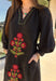 Bring elegance to the winter season with this stunning black embroidered midi dress by Entro. Featuring beautiful burgundy and olive floral embroidery, this long sleeve dress combines cozy sophistication with timeless charm. The contrast trim v-neck and subtle side slits add a touch of movement, while the fully lined design ensures comfort and warmth. Perfect for winter gatherings, holiday dinners, or date nights, this dress is effortlessly refined for the season.