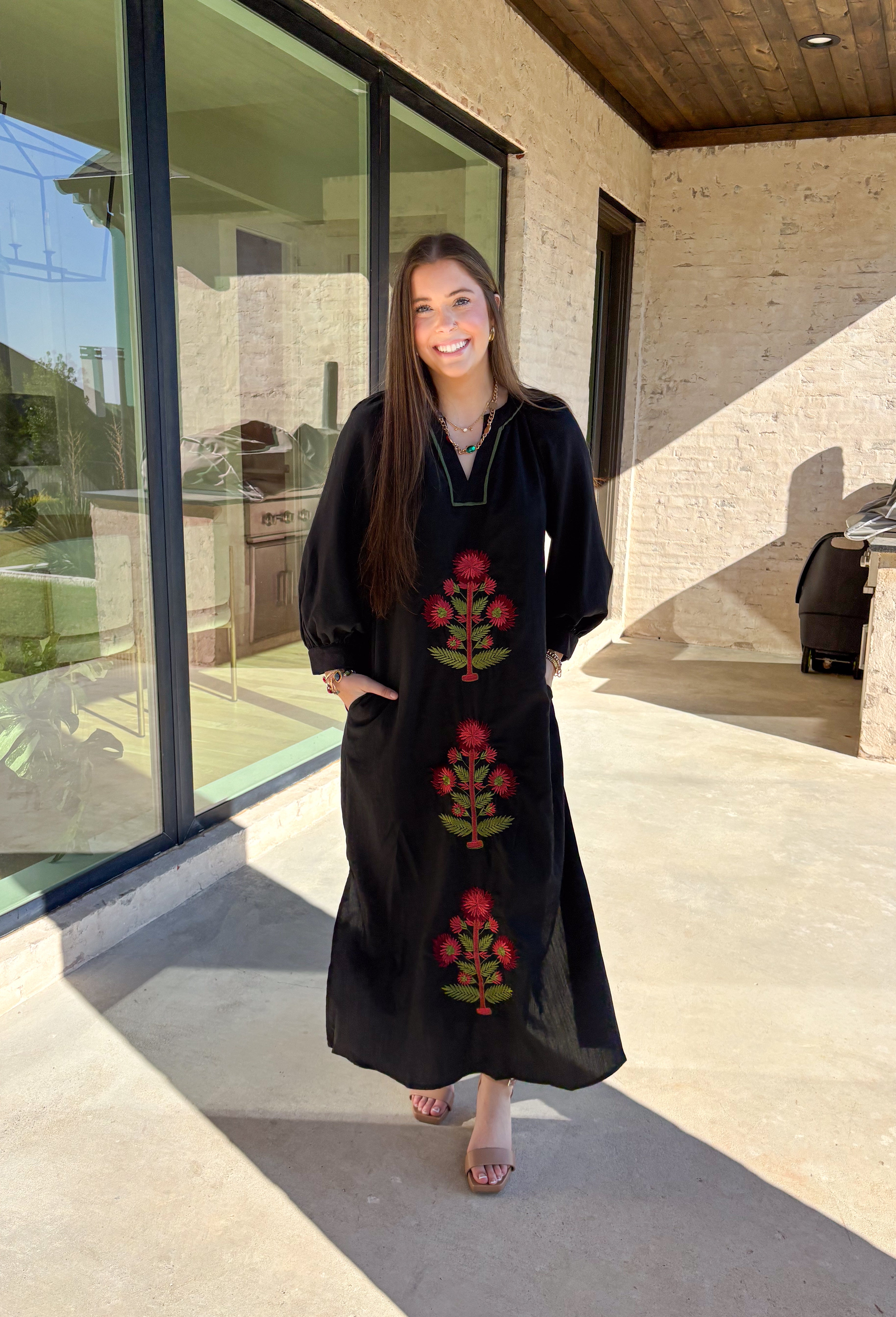 Bring elegance to the winter season with this stunning black embroidered midi dress by Entro. Featuring beautiful burgundy and olive floral embroidery, this long sleeve dress combines cozy sophistication with timeless charm. The contrast trim v-neck and subtle side slits add a touch of movement, while the fully lined design ensures comfort and warmth. Perfect for winter gatherings, holiday dinners, or date nights, this dress is effortlessly refined for the season.