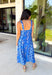 Feminine, fresh, and perfect for sunny days! This sleeveless blue midi dress features a beautiful floral print that feels soft and romantic. Darker blue trim paneling throughout adds a lovely contrast that highlights the silhouette and gives the dress a little extra detail. Smocking along the back and on the back straps creates a comfortable, flexible fit while keeping the shape flattering. 