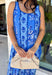 Feminine, fresh, and perfect for sunny days! This sleeveless blue midi dress features a beautiful floral print that feels soft and romantic. Darker blue trim paneling throughout adds a lovely contrast that highlights the silhouette and gives the dress a little extra detail. Smocking along the back and on the back straps creates a comfortable, flexible fit while keeping the shape flattering. 