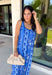 Feminine, fresh, and perfect for sunny days! This sleeveless blue midi dress features a beautiful floral print that feels soft and romantic. Darker blue trim paneling throughout adds a lovely contrast that highlights the silhouette and gives the dress a little extra detail. Smocking along the back and on the back straps creates a comfortable, flexible fit while keeping the shape flattering. 