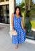 Feminine, fresh, and perfect for sunny days! This sleeveless blue midi dress features a beautiful floral print that feels soft and romantic. Darker blue trim paneling throughout adds a lovely contrast that highlights the silhouette and gives the dress a little extra detail. Smocking along the back and on the back straps creates a comfortable, flexible fit while keeping the shape flattering. 