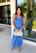 Feminine, fresh, and perfect for sunny days! This sleeveless blue midi dress features a beautiful floral print that feels soft and romantic. Darker blue trim paneling throughout adds a lovely contrast that highlights the silhouette and gives the dress a little extra detail. Smocking along the back and on the back straps creates a comfortable, flexible fit while keeping the shape flattering. 