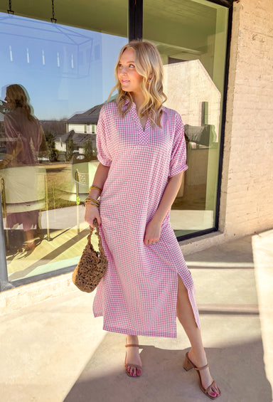 Sweet, classic, and perfect for spring days, this pink and white mini gingham midi dress is an effortless favorite. The timeless gingham print feels fresh and cheerful, while the collared neckline adds a polished touch. Elastic short sleeves keep it comfortable and easy to wear, and side pockets make it as practical as it is cute. With a flattering midi length and lightweight feel, this dress is ready for everything from brunch to casual spring outings.