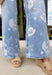 These light wash floral flare jeans are giving major retro summer energy in the best way! Designed with a super high-rise fit and an extreme vintage flare leg, they instantly elongate your silhouette while making a statement. The muted floral print adds a soft, feminine touch that feels unique but still easy to style for everyday wear. Pair them with a simple tank, graphic tee, or lightweight blouse and let the jeans do all the talking. 