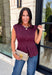 Rich seasonal color meets effortless style in this beautiful burgundy sleeveless top. Designed with flattering pleated waist detailing, this timeless piece creates a polished silhouette that's easy to dress up or down. The soft knit fabric offers all-day comfort, making it perfect for layering under blazers and jackets throughout the fall or wearing on its own during warmer autumn afternoons. 