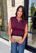 Rich seasonal color meets effortless style in this beautiful burgundy sleeveless top. Designed with flattering pleated waist detailing, this timeless piece creates a polished silhouette that's easy to dress up or down. The soft knit fabric offers all-day comfort, making it perfect for layering under blazers and jackets throughout the fall or wearing on its own during warmer autumn afternoons. 