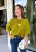 A rich olive green gets a pretty update with this pearl-detailed short sleeve sweater from Glam. Pearl detailing throughout adds a special touch to the soft knit, making it easy to dress up while still keeping that cozy, everyday feel. Exposed hems bring in a relaxed finish, while ribbed detailing along the neckline, sleeve cuffs, and hem gives it a classic sweater look. Wear it to the office, dinner plans, or anytime your outfit could use a little something extra.