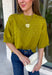 A rich olive green gets a pretty update with this pearl-detailed short sleeve sweater from Glam. Pearl detailing throughout adds a special touch to the soft knit, making it easy to dress up while still keeping that cozy, everyday feel. Exposed hems bring in a relaxed finish, while ribbed detailing along the neckline, sleeve cuffs, and hem gives it a classic sweater look. Wear it to the office, dinner plans, or anytime your outfit could use a little something extra.