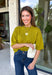 A rich olive green gets a pretty update with this pearl-detailed short sleeve sweater from Glam. Pearl detailing throughout adds a special touch to the soft knit, making it easy to dress up while still keeping that cozy, everyday feel. Exposed hems bring in a relaxed finish, while ribbed detailing along the neckline, sleeve cuffs, and hem gives it a classic sweater look. Wear it to the office, dinner plans, or anytime your outfit could use a little something extra.