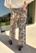 Make a statement with these effortlessly stylish cropped wide leg pants from Entro. Designed in an eye-catching ecru and brown snake print, these versatile pants bring the perfect mix of bold style and everyday comfort. The flattering wide leg silhouette and cropped length create a modern look that's easy to dress up or down, while the classic zip-fly button closure and functional pockets make them as practical as they are chic.