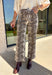 Make a statement with these effortlessly stylish cropped wide leg pants from Entro. Designed in an eye-catching ecru and brown snake print, these versatile pants bring the perfect mix of bold style and everyday comfort. The flattering wide leg silhouette and cropped length create a modern look that's easy to dress up or down, while the classic zip-fly button closure and functional pockets make them as practical as they are chic.