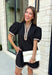 Classic with a modern twist, this black dress is the definition of effortless fall style. Classic black is beautifully accented with tan and cream trim along the front, sides, hem, and sleeves for a look that feels both timeless and eye-catching. The front button details and soft puff sleeves add just the right amount of charm, while the fully lined design and side pockets make it as comfortable as it is stylish. 