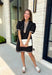 Classic with a modern twist, this black dress is the definition of effortless fall style. Classic black is beautifully accented with tan and cream trim along the front, sides, hem, and sleeves for a look that feels both timeless and eye-catching. The front button details and soft puff sleeves add just the right amount of charm, while the fully lined design and side pockets make it as comfortable as it is stylish. 