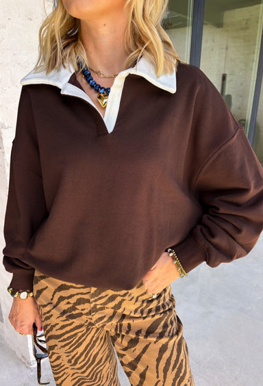 Cozy comfort meets timeless style in this effortlessly chic pullover from The Blank Lab. Designed in a rich chocolate brown hue, this lightweight sweatshirt is accented with a crisp off-white collar that gives it a polished, layered look without sacrificing comfort. Crafted from soft 100% cotton, it's the perfect throw-on piece for crisp fall mornings, casual coffee runs, or relaxing weekends. Easy to dress up or down, this classic pullover is sure to become a favorite all season long.