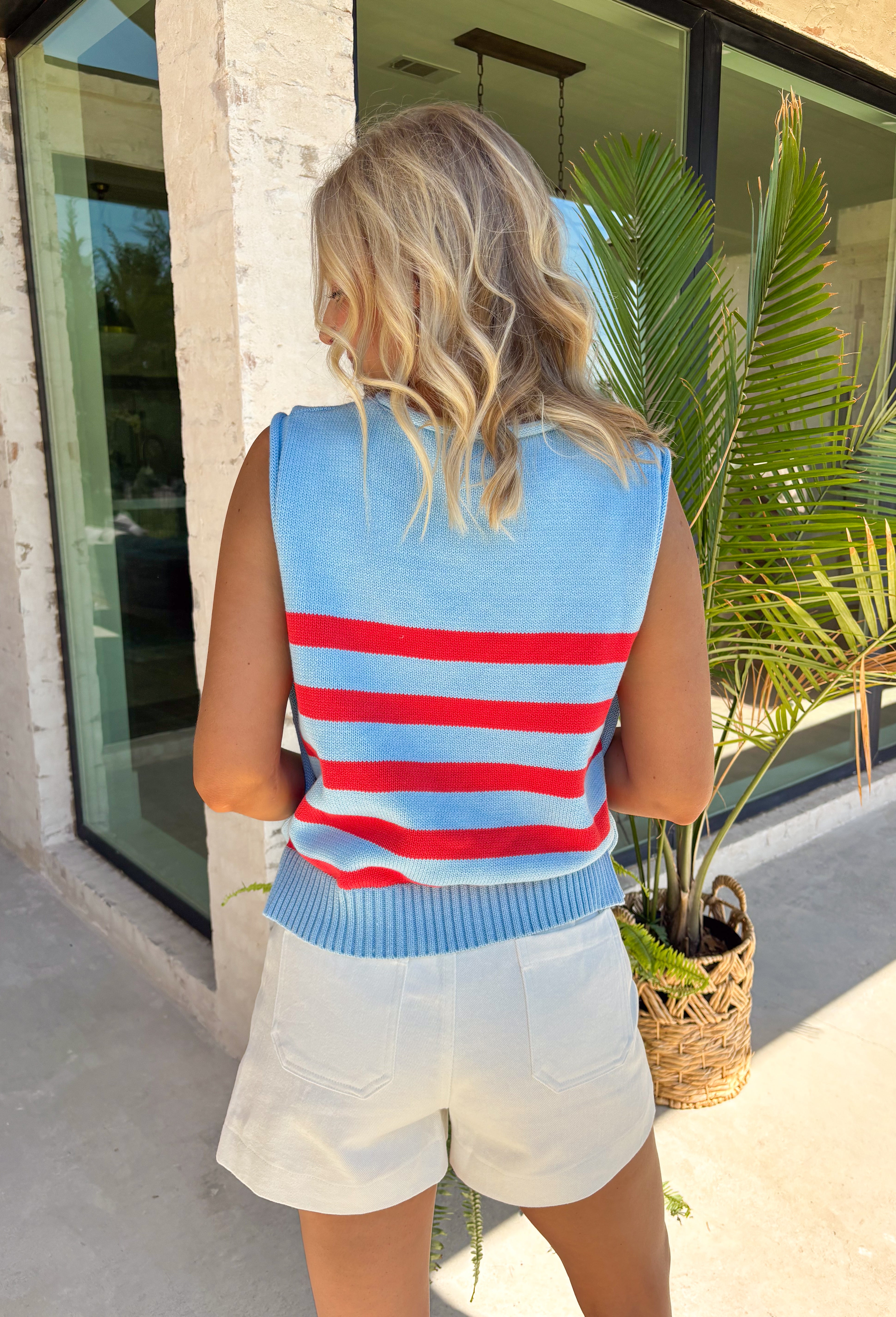 This light blue striped sweater tank is the perfect mix of classic and festive for summer! Featuring a red stripe print, it’s a subtle nod to patriotic style—perfect for the 4th of July and all your warm-weather plans. The ribbed crew neckline and hem give it a clean, polished look, while the functional gold button details along the sides add an elevated, eye-catching touch. Made from breathable cotton, it’s lightweight and easy to wear from day to night.