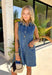 This sleeveless denim mini dress is the perfect mix of classic and cool for summer. Designed with a button front and front flap pockets featuring buckle accents, it brings a subtle utility vibe that feels both trendy and timeless. The lightweight cotton keeps it breathable for warm days, while the structured shape makes it easy to dress up or down. Whether you're heading to brunch, running errands, or packing for vacation, this is one of those throw-on-and-go pieces that always works. 