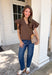 Simple details make all the difference in this effortlessly beautiful brown top! Crafted from a breathable cotton and linen blend, this timeless top is perfect for transitioning through the fall season. The flattering v-neckline is accented with delicate stitch detailing, while flutter sleeves add a soft, feminine touch. A button closure at the back completes the look with subtle charm. 
