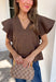 Simple details make all the difference in this effortlessly beautiful brown top! Crafted from a breathable cotton and linen blend, this timeless top is perfect for transitioning through the fall season. The flattering v-neckline is accented with delicate stitch detailing, while flutter sleeves add a soft, feminine touch. A button closure at the back completes the look with subtle charm. 