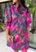Make every occasion feel a little more special in this beautifully detailed dress from Entro. Featuring a stunning abstract print in rich shades of magenta, olive, navy, and pink, this feminine dress is full of eye-catching seasonal color. The ruffled mock neckline and button-front design create a timeless silhouette, while the matching self-tie belt flatters your waist for a customizable fit. Puff sleeves with elastic ruffle cuffs add a sweet finishing touch, and side pockets make it as practical.