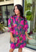 Make every occasion feel a little more special in this beautifully detailed dress from Entro. Featuring a stunning abstract print in rich shades of magenta, olive, navy, and pink, this feminine dress is full of eye-catching seasonal color. The ruffled mock neckline and button-front design create a timeless silhouette, while the matching self-tie belt flatters your waist for a customizable fit. Puff sleeves with elastic ruffle cuffs add a sweet finishing touch, and side pockets make it as practical.