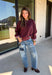 A cozy sweater with a little extra personality! This rich plum sweater features contrasting mauve exposed hems that add a soft, lived-in touch to the classic silhouette. The ribbed hem and sleeves create a comfortable fit while giving the sweater just the right amount of texture. Easy to style and perfect for chilly days, this cozy knit will quickly become a favorite for coffee runs, casual weekends, and fall outings.