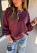 A cozy sweater with a little extra personality! This rich plum sweater features contrasting mauve exposed hems that add a soft, lived-in touch to the classic silhouette. The ribbed hem and sleeves create a comfortable fit while giving the sweater just the right amount of texture. Easy to style and perfect for chilly days, this cozy knit will quickly become a favorite for coffee runs, casual weekends, and fall outings.