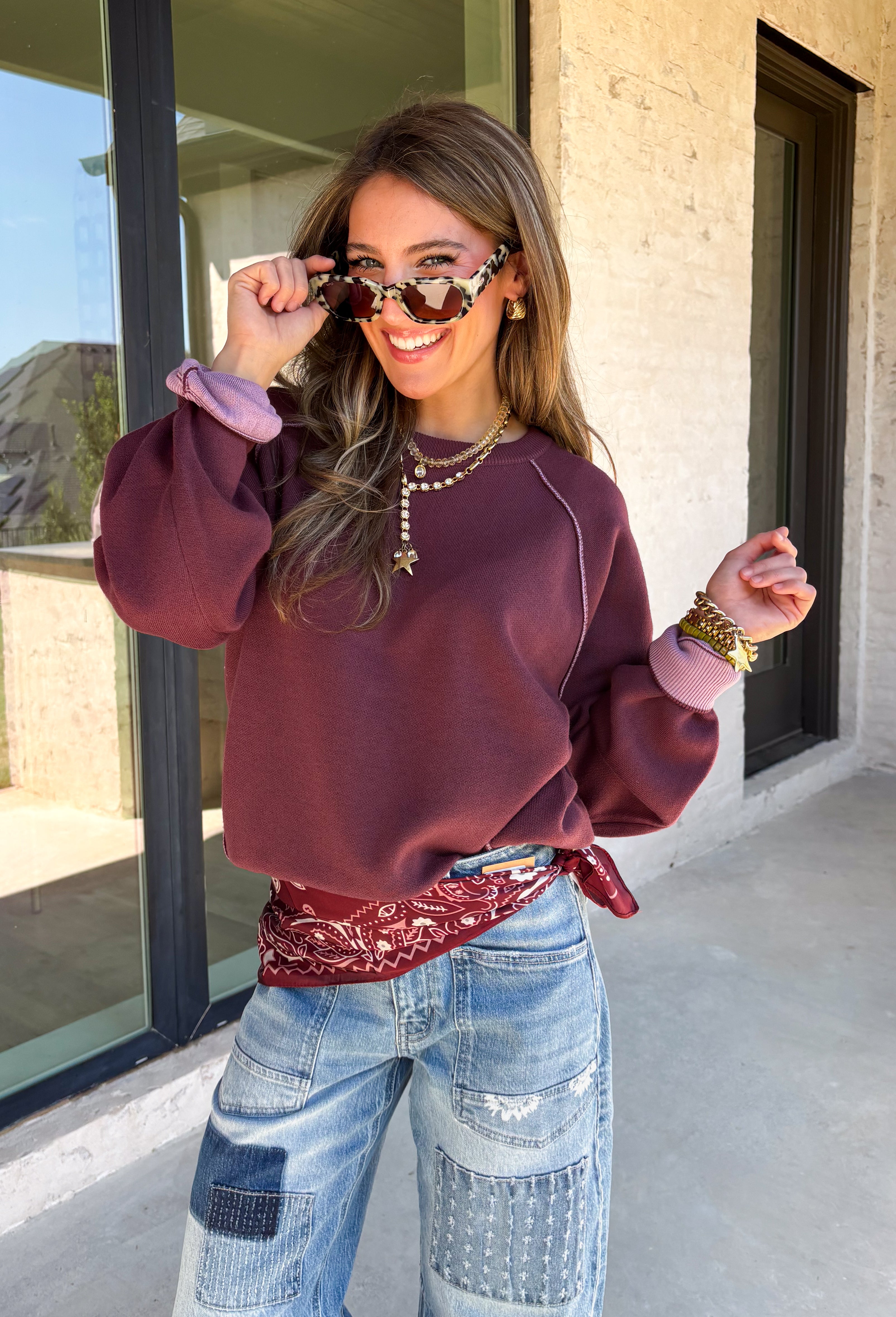 A cozy sweater with a little extra personality! This rich plum sweater features contrasting mauve exposed hems that add a soft, lived-in touch to the classic silhouette. The ribbed hem and sleeves create a comfortable fit while giving the sweater just the right amount of texture. Easy to style and perfect for chilly days, this cozy knit will quickly become a favorite for coffee runs, casual weekends, and fall outings.