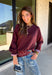 A cozy sweater with a little extra personality! This rich plum sweater features contrasting mauve exposed hems that add a soft, lived-in touch to the classic silhouette. The ribbed hem and sleeves create a comfortable fit while giving the sweater just the right amount of texture. Easy to style and perfect for chilly days, this cozy knit will quickly become a favorite for coffee runs, casual weekends, and fall outings.