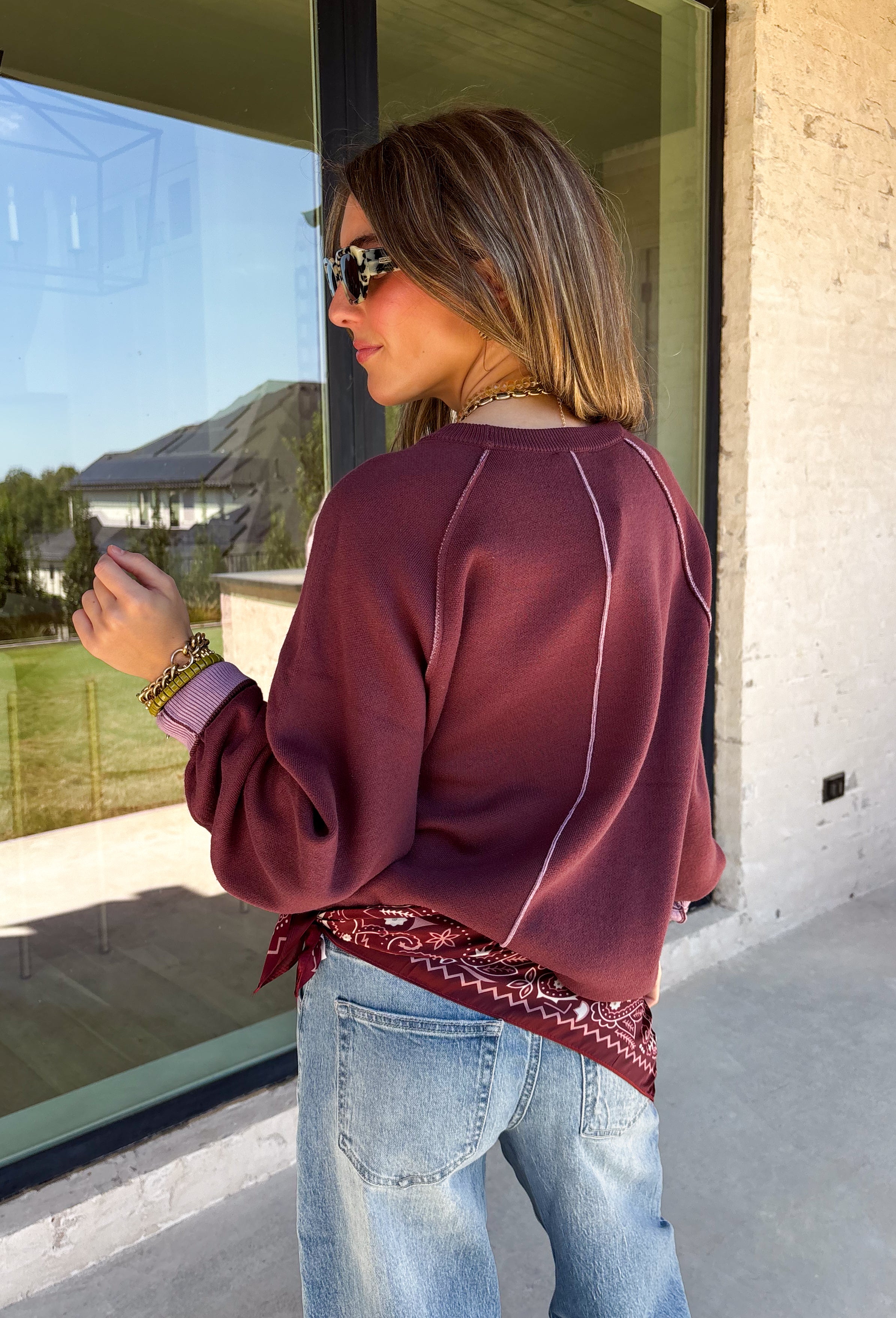 A cozy sweater with a little extra personality! This rich plum sweater features contrasting mauve exposed hems that add a soft, lived-in touch to the classic silhouette. The ribbed hem and sleeves create a comfortable fit while giving the sweater just the right amount of texture. Easy to style and perfect for chilly days, this cozy knit will quickly become a favorite for coffee runs, casual weekends, and fall outings.