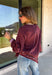 A cozy sweater with a little extra personality! This rich plum sweater features contrasting mauve exposed hems that add a soft, lived-in touch to the classic silhouette. The ribbed hem and sleeves create a comfortable fit while giving the sweater just the right amount of texture. Easy to style and perfect for chilly days, this cozy knit will quickly become a favorite for coffee runs, casual weekends, and fall outings.