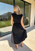 Meet your new throw-on-and-go favorite with this black utility-inspired midi dress from Entro. The classic black color keeps it versatile, while the zipper-front closure and adjustable waist give it a sporty, modern feel. A bubble hem adds shape and a fun unexpected finish, while the sleeveless silhouette makes it easy to wear now and layer as the temperatures cool down. Complete with convenient side pockets, this dress is ready for busy workdays, weekend plans, travel days, and everything in between.