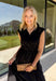 Meet your new throw-on-and-go favorite with this black utility-inspired midi dress from Entro. The classic black color keeps it versatile, while the zipper-front closure and adjustable waist give it a sporty, modern feel. A bubble hem adds shape and a fun unexpected finish, while the sleeveless silhouette makes it easy to wear now and layer as the temperatures cool down. Complete with convenient side pockets, this dress is ready for busy workdays, weekend plans, travel days, and everything in between.