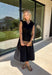 Meet your new throw-on-and-go favorite with this black utility-inspired midi dress from Entro. The classic black color keeps it versatile, while the zipper-front closure and adjustable waist give it a sporty, modern feel. A bubble hem adds shape and a fun unexpected finish, while the sleeveless silhouette makes it easy to wear now and layer as the temperatures cool down. Complete with convenient side pockets, this dress is ready for busy workdays, weekend plans, travel days, and everything in between.