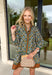 Chic and full of seasonal charm, this hunter green mini dress by Entro brings a fresh take on winter dressing. Featuring a geometric print in tan, white, brown, and lavender, it adds a modern twist to your cold-weather wardrobe. The contrast binding and ruffle hem offer feminine flair, while the lined design and side pocket make it as comfortable as it is stylish.