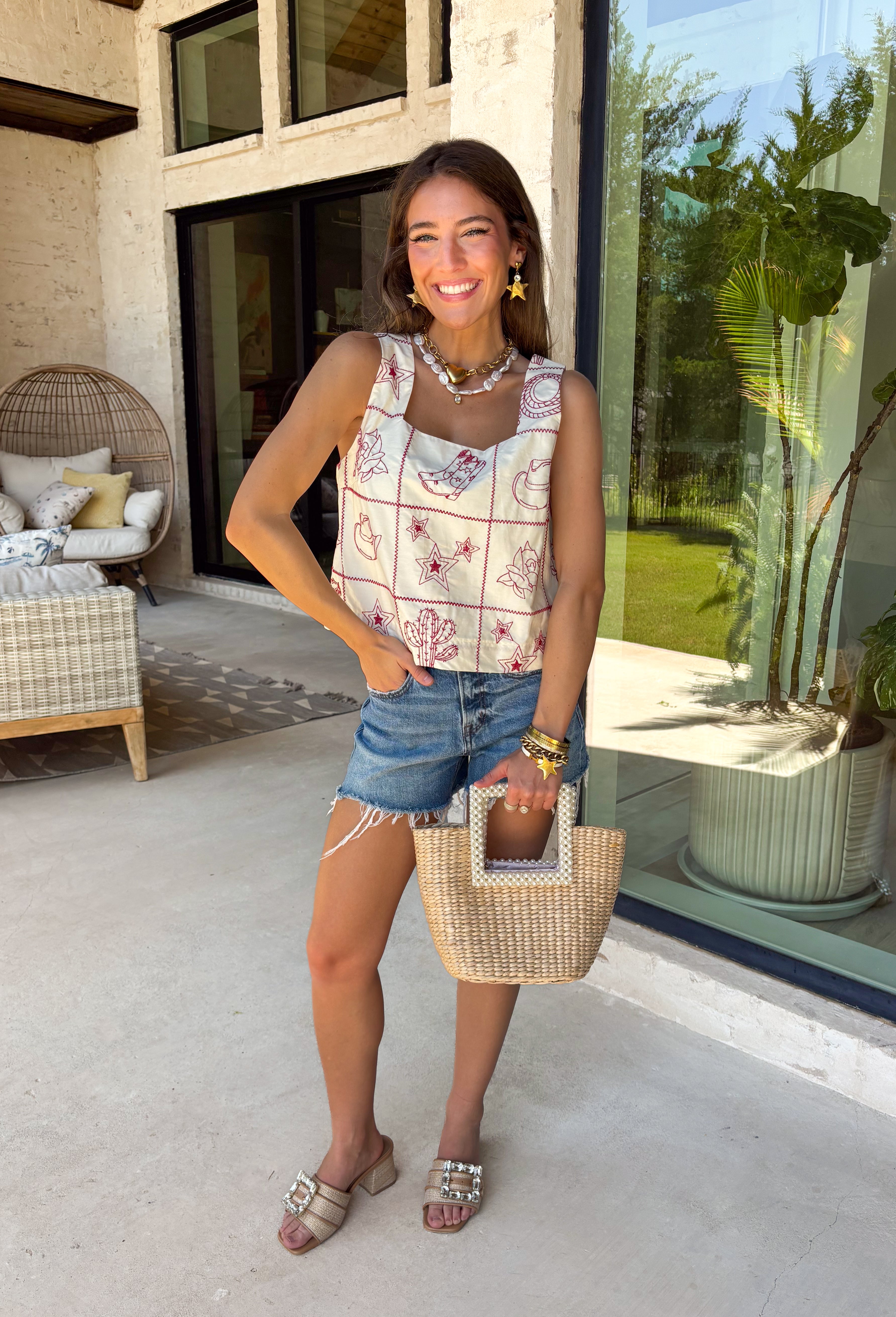 This ecru sleeveless top by Entro is giving sweet spring style with a little western twist. Featuring bold red novelty embroidery, it’s the perfect statement piece for sunny days, rodeo nights, and everything in between. The cropped length keeps it fun and flirty, while the square neckline adds a clean, flattering shape that pairs perfectly with high-rise denim.