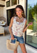 This ecru sleeveless top by Entro is giving sweet spring style with a little western twist. Featuring bold red novelty embroidery, it’s the perfect statement piece for sunny days, rodeo nights, and everything in between. The cropped length keeps it fun and flirty, while the square neckline adds a clean, flattering shape that pairs perfectly with high-rise denim.