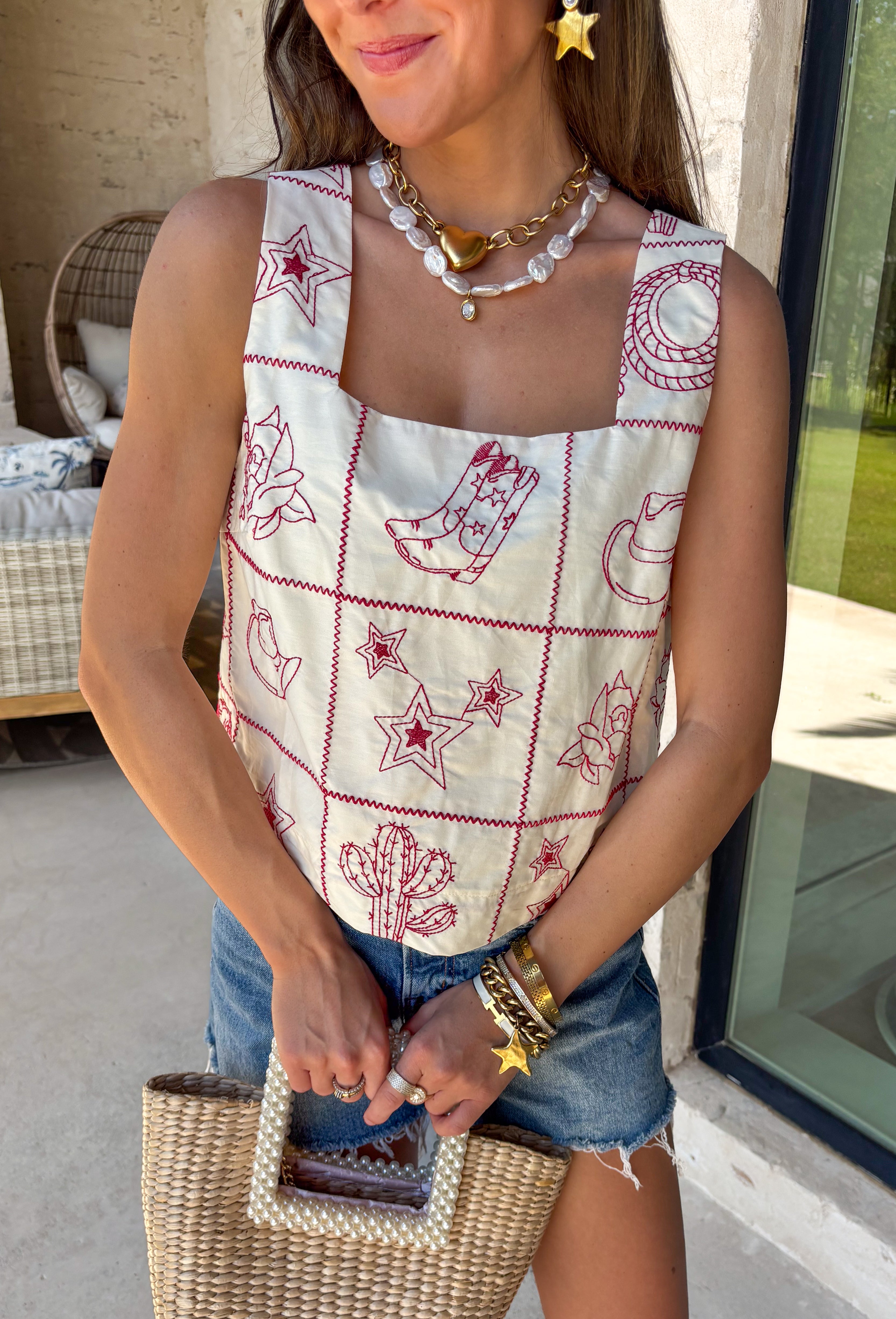 This ecru sleeveless top by Entro is giving sweet spring style with a little western twist. Featuring bold red novelty embroidery, it’s the perfect statement piece for sunny days, rodeo nights, and everything in between. The cropped length keeps it fun and flirty, while the square neckline adds a clean, flattering shape that pairs perfectly with high-rise denim.