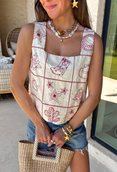 This ecru sleeveless top by Entro is giving sweet spring style with a little western twist. Featuring bold red novelty embroidery, it’s the perfect statement piece for sunny days, rodeo nights, and everything in between. The cropped length keeps it fun and flirty, while the square neckline adds a clean, flattering shape that pairs perfectly with high-rise denim.